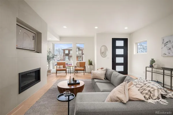 a living room with furniture and a fireplace