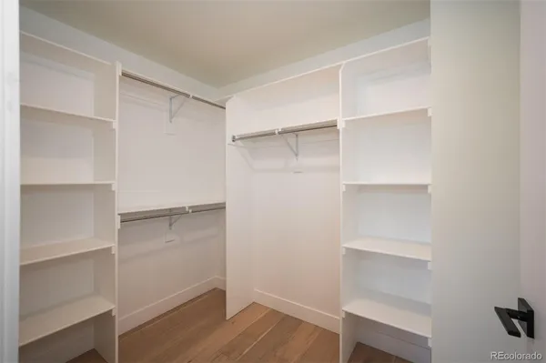 a view of walk in closet with empty racks