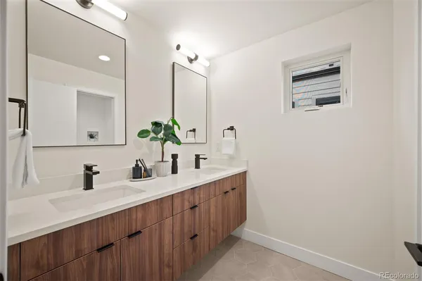 a bathroom with a double vanity sink and a mirror