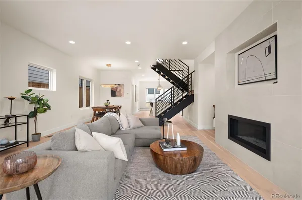 a living room with furniture a lamp and a fireplace