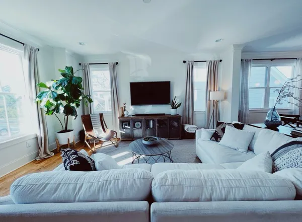 a living room with furniture and a flat screen tv
