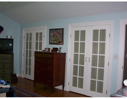 33 Pine Ridge Road Wellesley, MA 02481 - Photo 11 of 27 a view of a bedroom with wooden floor and windows