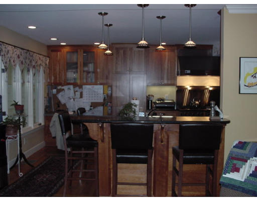 33 Pine Ridge Road Wellesley, MA 02481 - Photo 21 of 27 a kitchen with a dining table chairs and white cabinets