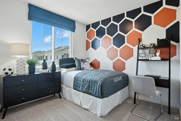 a bedroom with a bed and a mirror