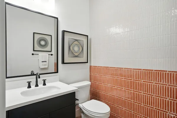 a bathroom with a toilet a sink and mirror