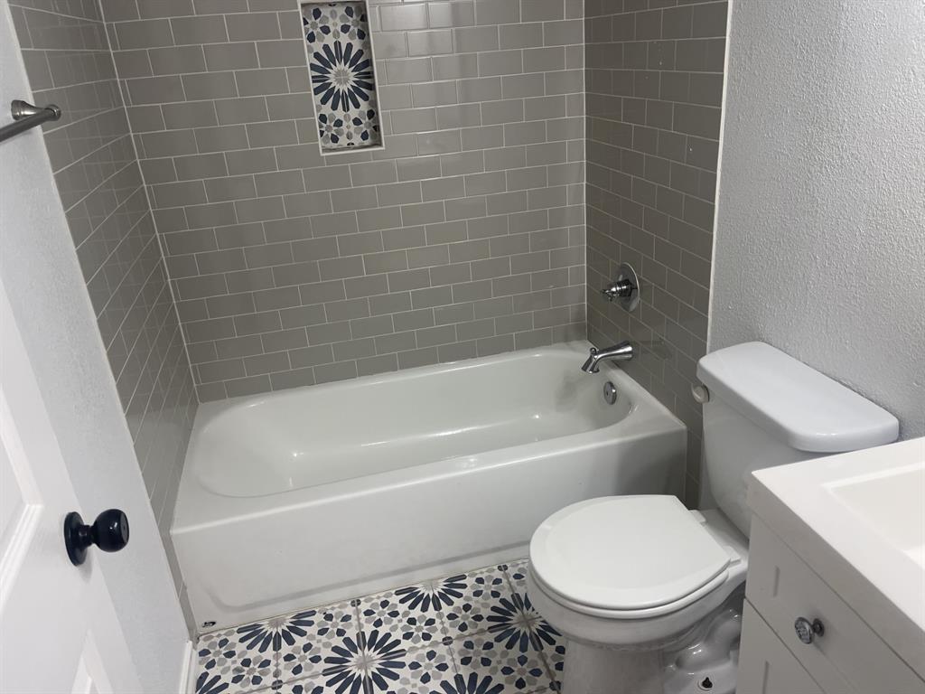 411 Smith Street Bonham, TX 75418 - Photo 15 of 22 Full bathroom with vanity, bathing tub / shower combination, and tile patterned flooring