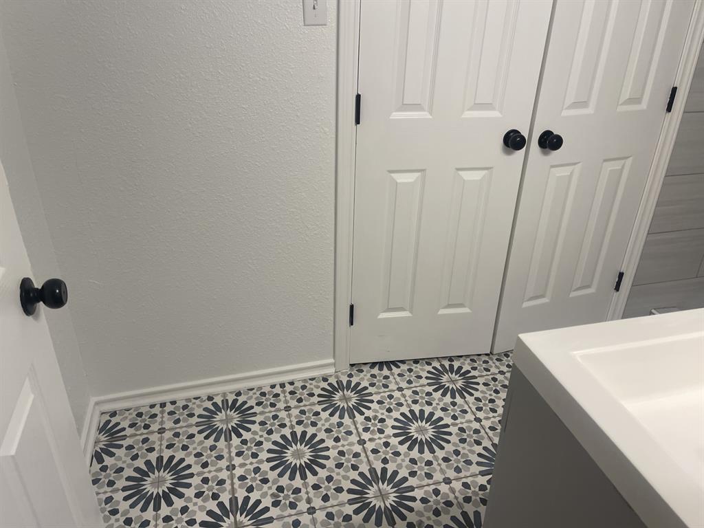 411 Smith Street Bonham, TX 75418 - Photo 10 of 22 Double doors lead to the primary bedroom closet