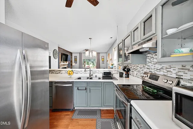 a kitchen with stainless steel appliances a sink stove and refrigerator
