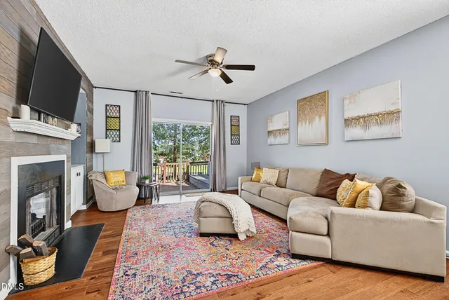 a living room with furniture fireplace and flat screen tv