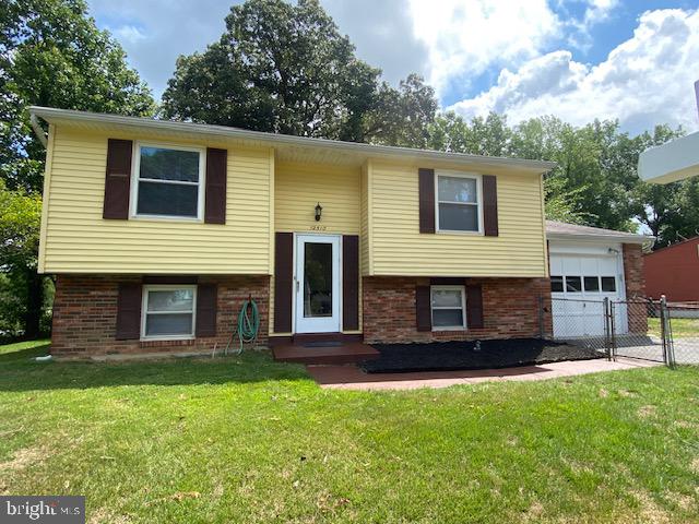 Front View-Fenced In Yard with flower beds