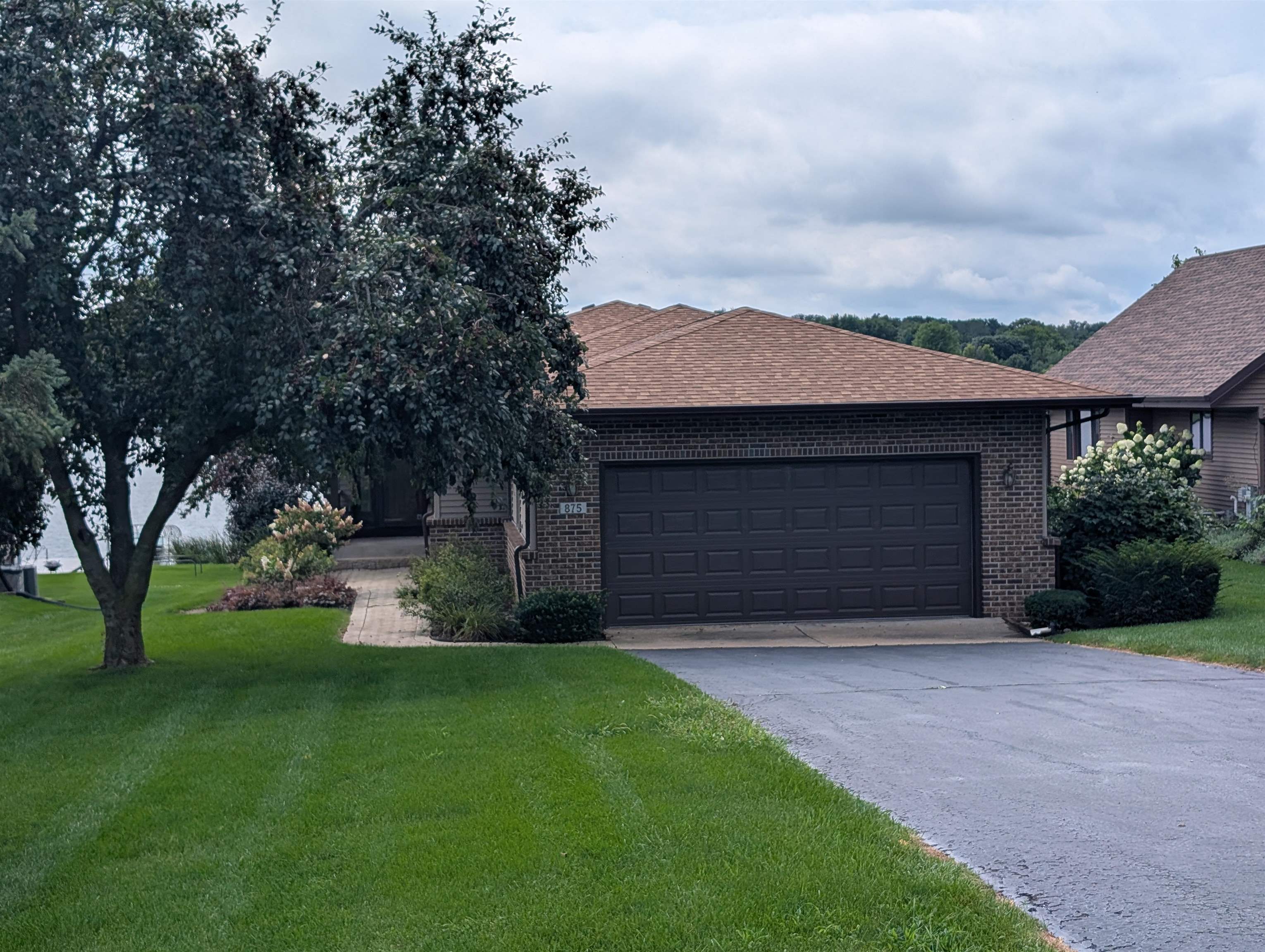 a front view of a house with a garden and yard
