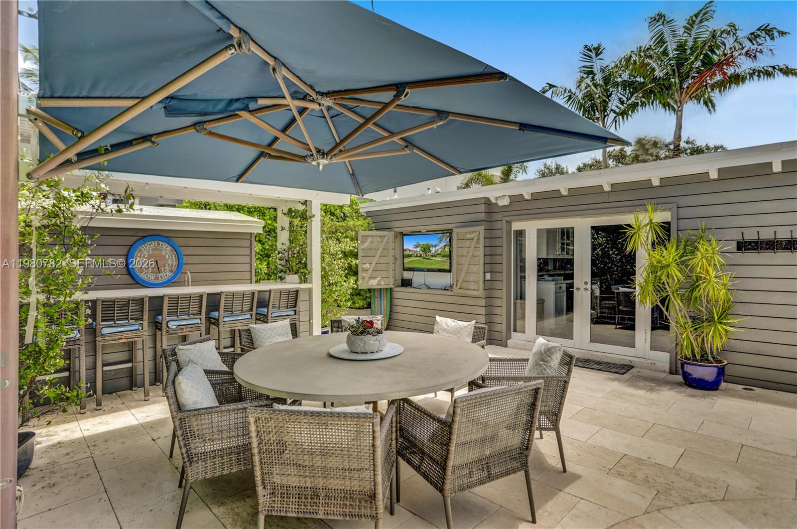 462 Glenridge Road Key Biscayne, FL 33149 - Photo 11 of 32 a patio with a table and chairs