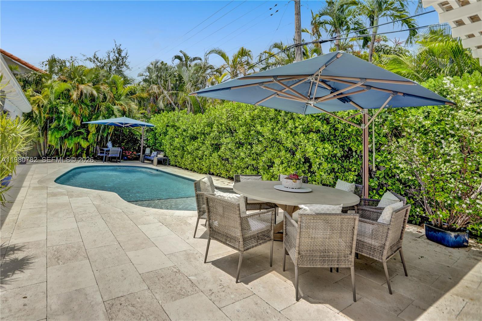 462 Glenridge Road Key Biscayne, FL 33149 - Photo 12 of 32 a patio with a patio table and chairs