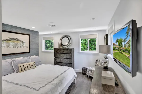 a bedroom with a bed and a flat screen tv