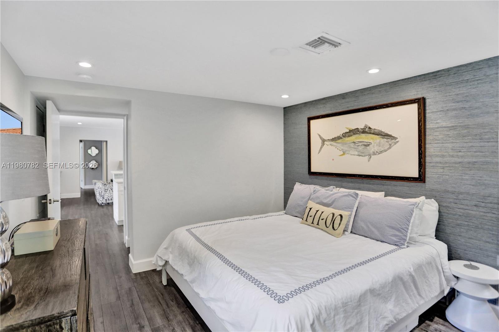 462 Glenridge Road Key Biscayne, FL 33149 - Photo 14 of 32 a bedroom with a bed and a painting on the wall