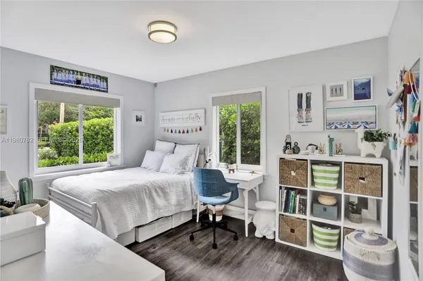 a bedroom with a bed and a wooden floor