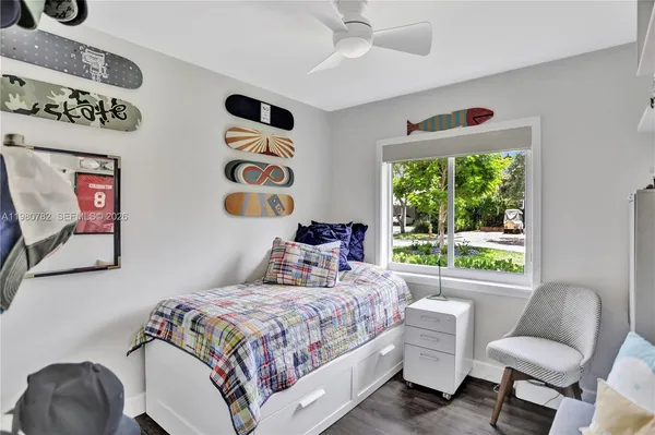 a bedroom with a bed and a chair with the outer view