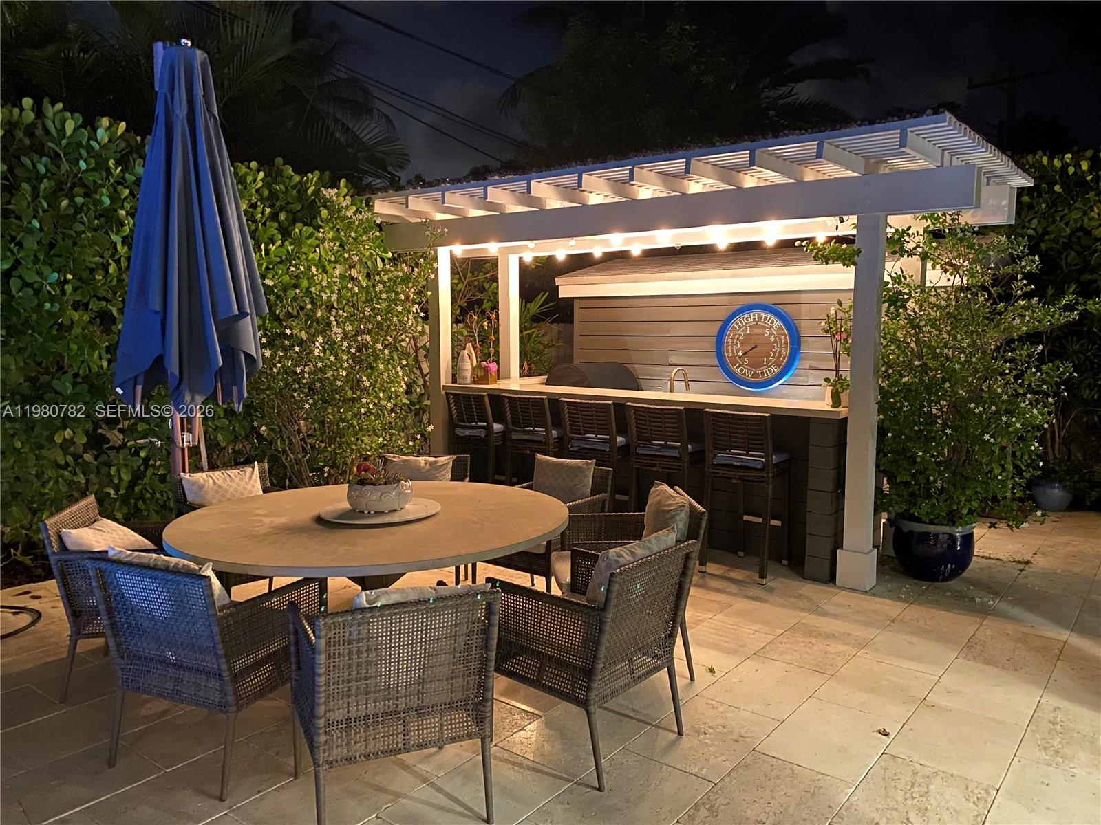 462 Glenridge Road Key Biscayne, FL 33149 - Photo 24 of 32 a table and chairs in front of a building