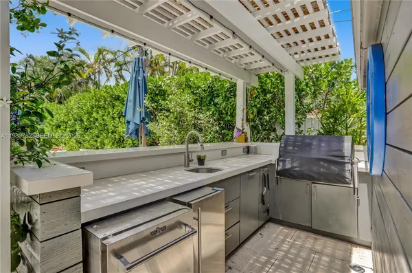 a kitchen with a sink and large trees