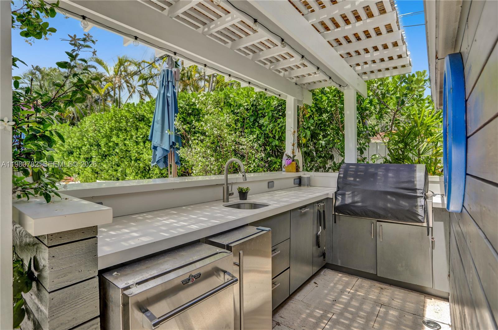 462 Glenridge Road Key Biscayne, FL 33149 - Photo 27 of 32 a kitchen with a sink and large trees