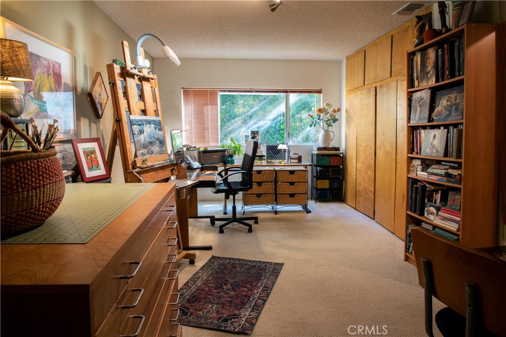 2700 Mill Creek Road Mentone, CA 92359 - Photo 7 of 22 a living room with furniture a bookshelf and a large window