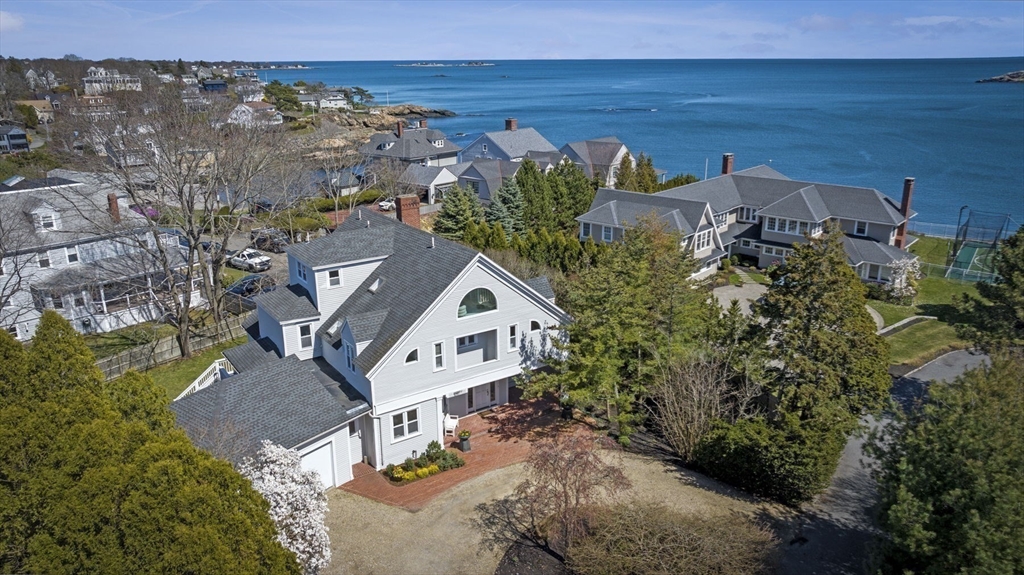 an aerial view of a house with outdoor space and lake view