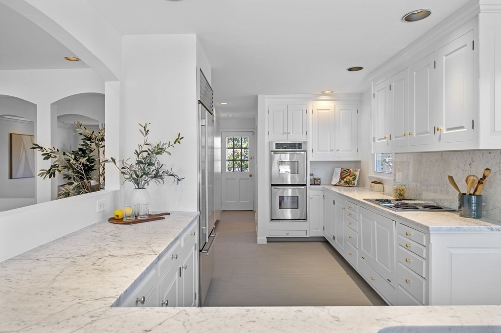 10 Rolleston Road Marblehead, MA 01945 - Photo 16 of 42 a kitchen with granite countertop a sink stove and cabinets