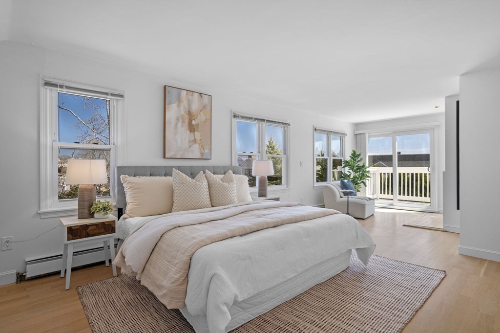 10 Rolleston Road Marblehead, MA 01945 - Photo 21 of 42 a bedroom with a large bed a chandelier and windows