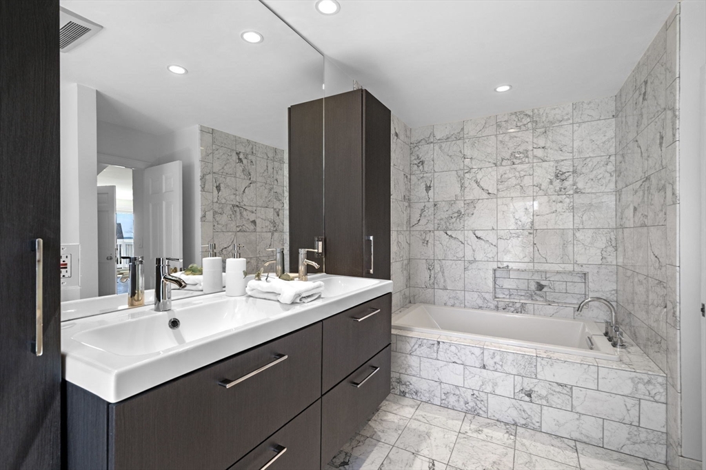 10 Rolleston Road Marblehead, MA 01945 - Photo 22 of 42 a bathroom with a bathtub shower sink vanity and mirror