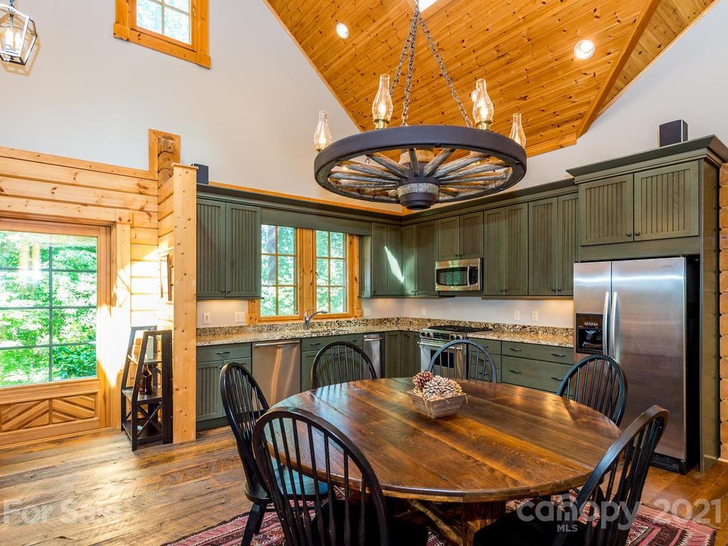 429 West Gate Road, Unit 24 Sylva, NC 28779 - Photo 14 of 35 a view of a dining room with furniture window and outside view