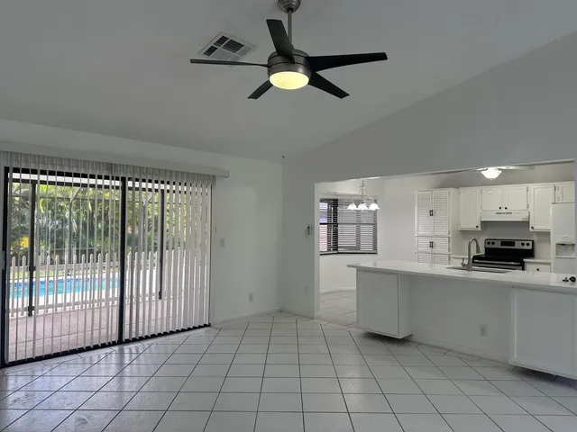 a kitchen with granite countertop a stove a sink and a window