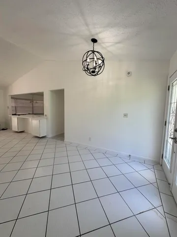 a view of an empty room and a window