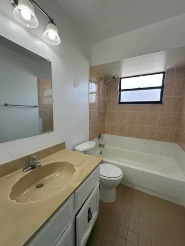 a bathroom with a sink a toilet and bathtub
