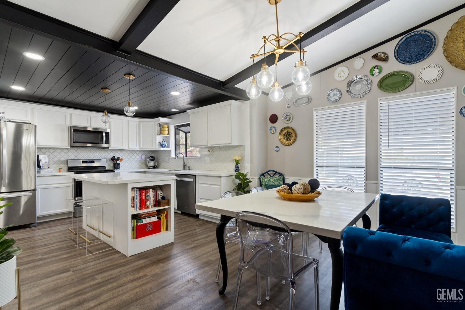 a open kitchen with stainless steel appliances granite countertop a stove and refrigerator