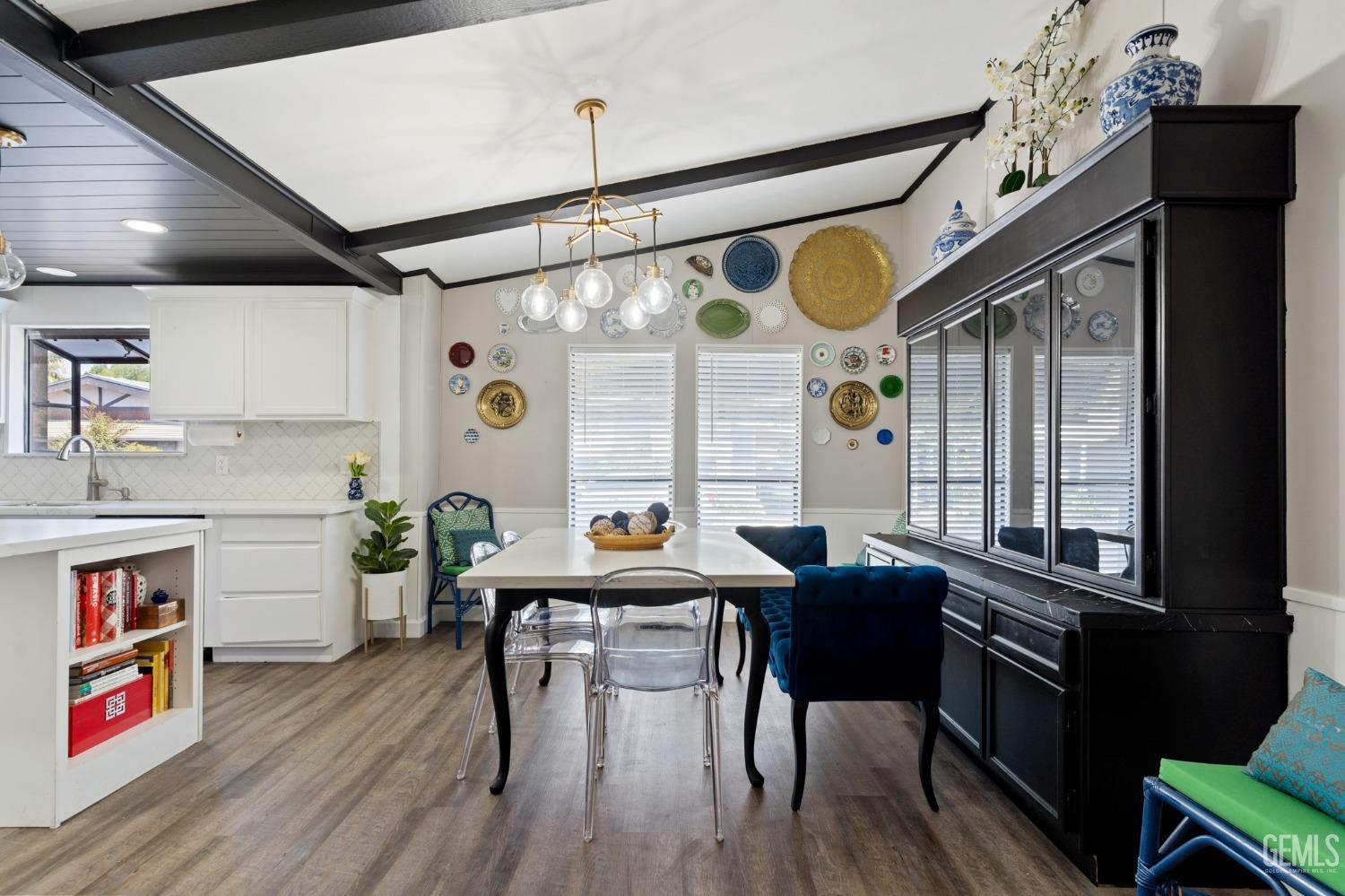 Undisclosed Address Bakersfield, CA 93306 - Photo 11 of 27 a open kitchen with stainless steel appliances granite countertop a stove a refrigerator a dining table and chairs with wooden floor