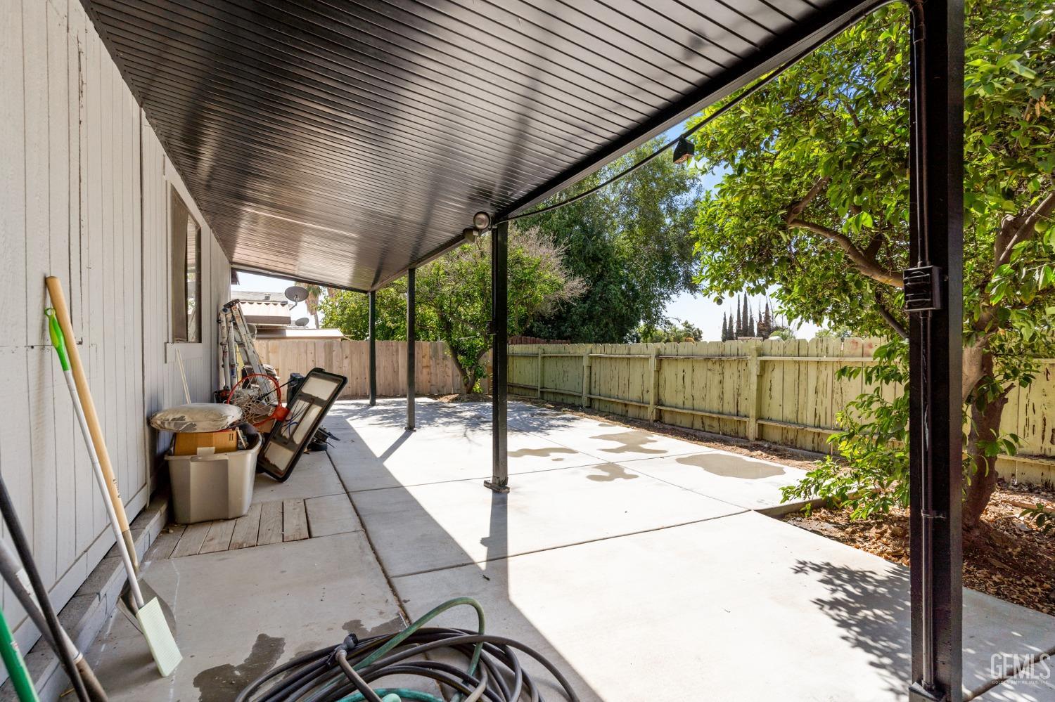 Undisclosed Address Bakersfield, CA 93306 - Photo 24 of 27 a view of a patio with table and chairs potted plants with wooden floor and fence