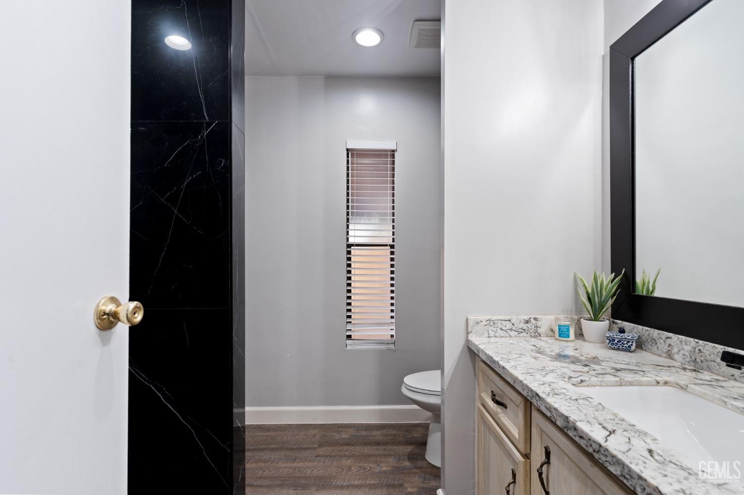 Undisclosed Address Bakersfield, CA 93306 - Photo 9 of 27 a bathroom with a granite countertop sink toilet and shower