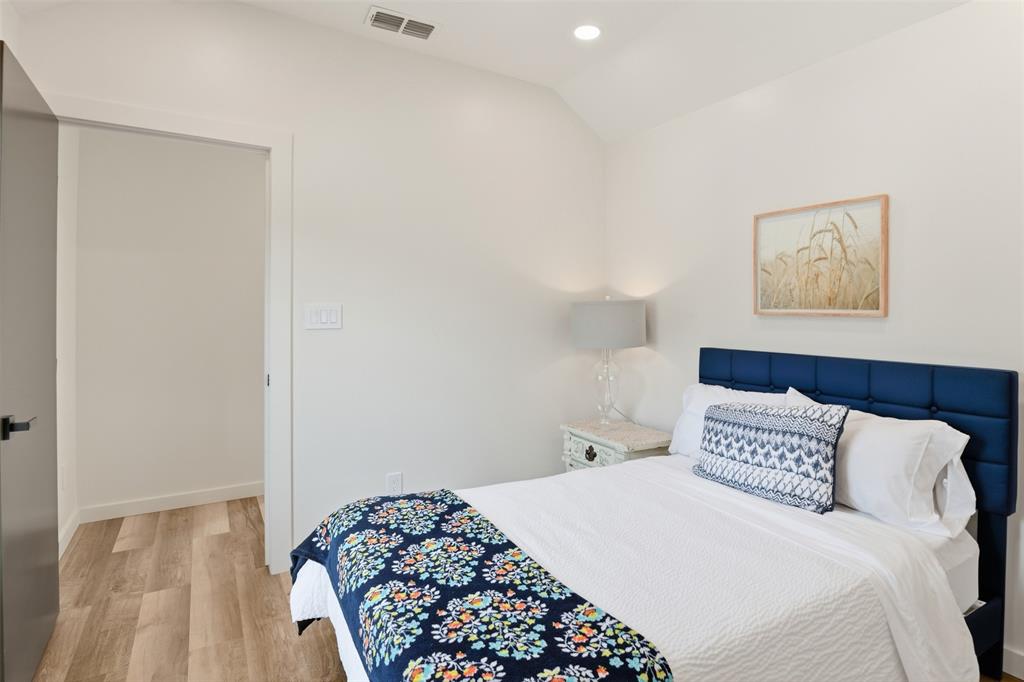 521 York Street Athens, TX 75751 - Photo 25 of 34 a bedroom with a bed and a painting on the wall