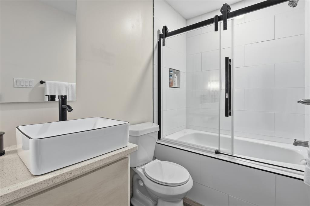 521 York Street Athens, TX 75751 - Photo 27 of 34 a bathroom with a shower a toilet and a sink
