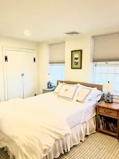 a bedroom with a bed and a night stand