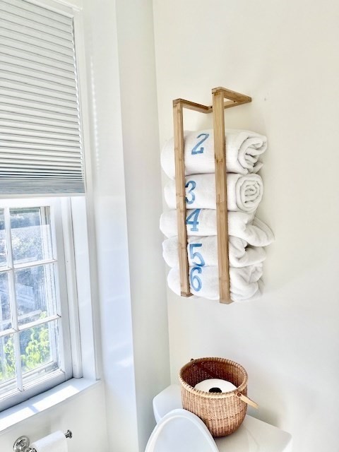 76 Orange Street Nantucket, MA 02554 - Photo 22 of 34 a bathroom with a toilet and a shower curtain