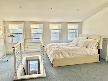 a spacious bedroom with a bed and a fireplace