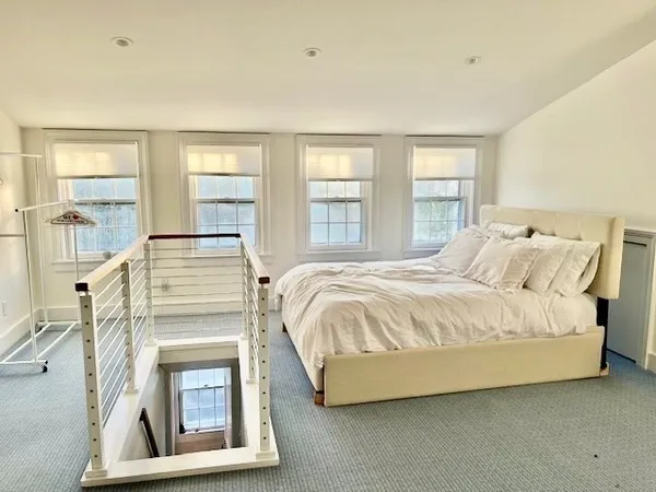 a spacious bedroom with a bed and a fireplace