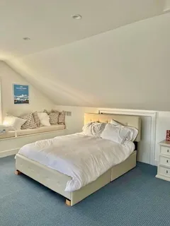 a bedroom with a bed and a lamp