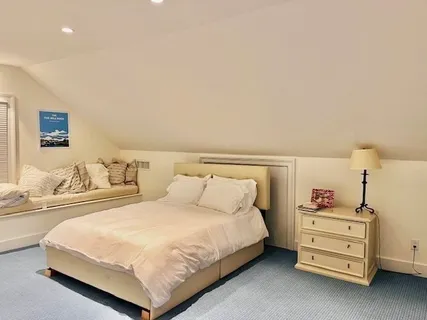 a bedroom with a bed and lamp