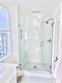 a bathroom with a granite countertop shower