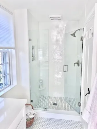 a bathroom with a granite countertop shower
