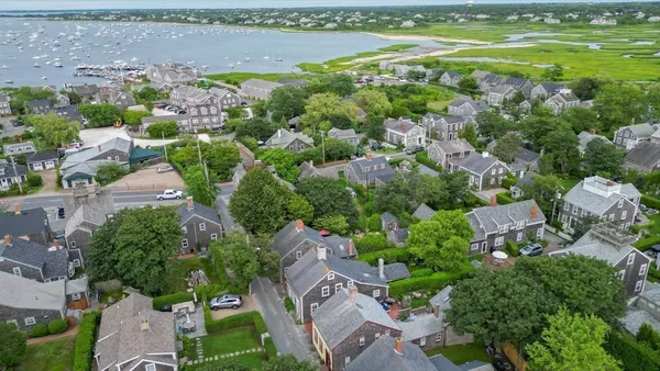 an aerial view of residential house with outdoor space and lake view