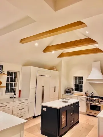 a kitchen with kitchen island sink stove and refrigerator