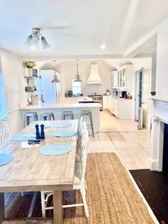 a living room with kitchen island granite countertop furniture and a wooden floor